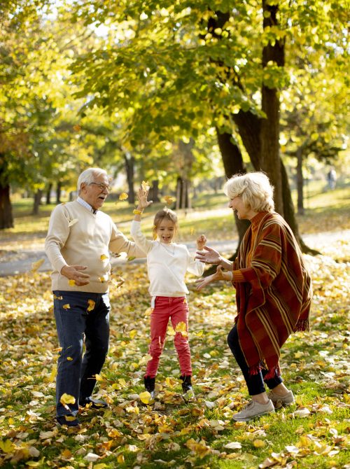 Grandparents enjoying good time with their cute little granddaughter